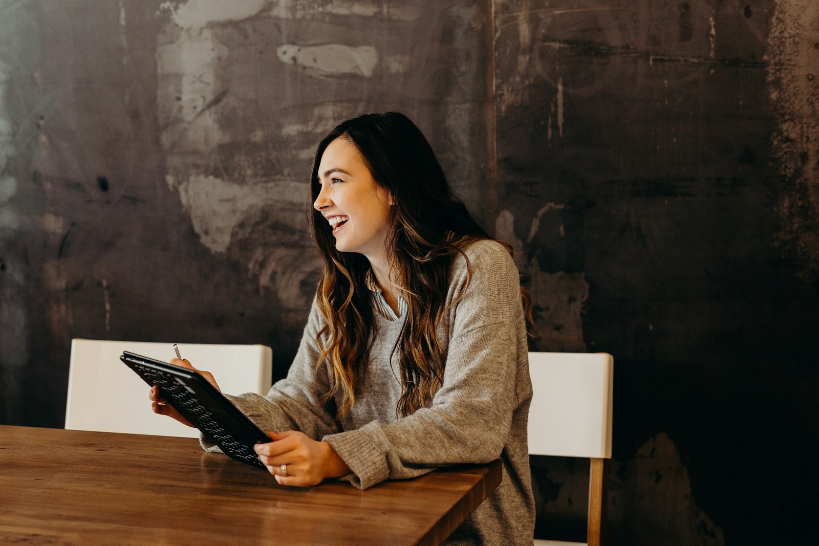 Smiling local business owner reviewing a website on a tablet