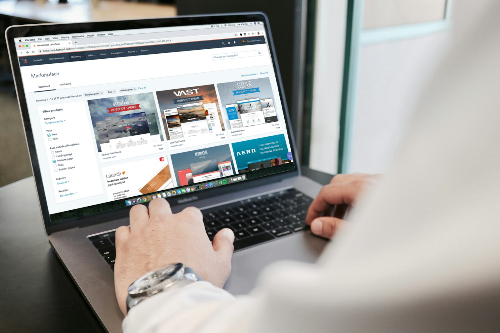 Person browsing a business website on a laptop during a website design project